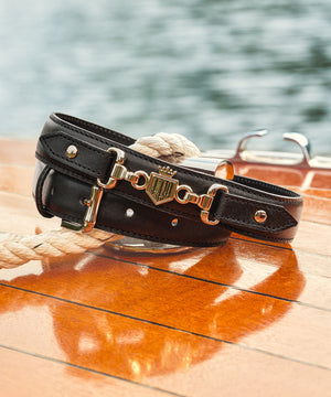 the Moulton belt in black leather rolled up showing the gold detail fairfax and favor hardware.