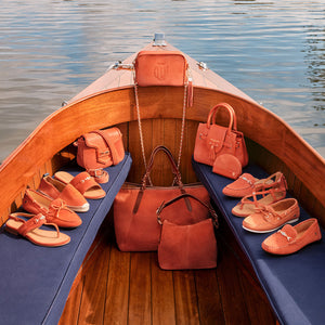the whole sunset orange collection on a boat. in sunshine.