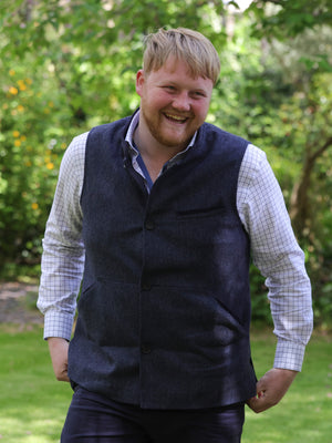 Kaleb from Clarksons Farm on amazon, wearing the edward gilet for men in navy, looking very happy and dapper.